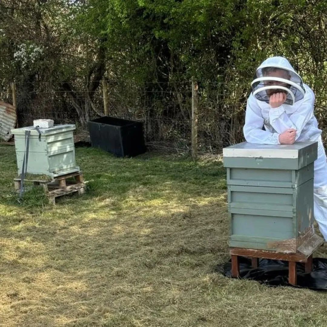 Chris Culshaw, beekeeper and founder of HiveKeeper, in bee suit at his apiary